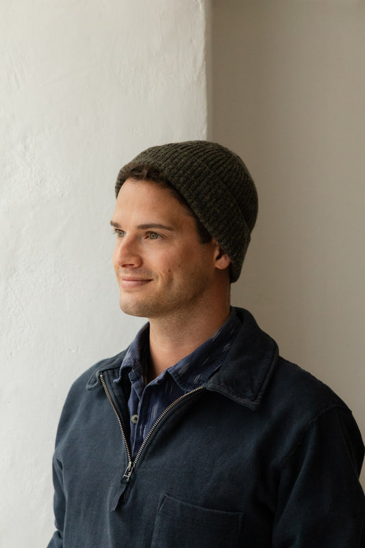 Man wearing a dark granite heather wool beanie and navy jacket