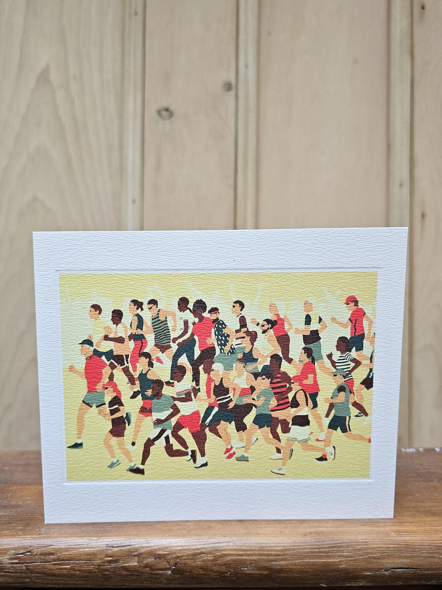 Greeting card reproducing Rachel Clark's linocut print of a record shop, showing five figures browsing through vinyl records with album covers lining the walls