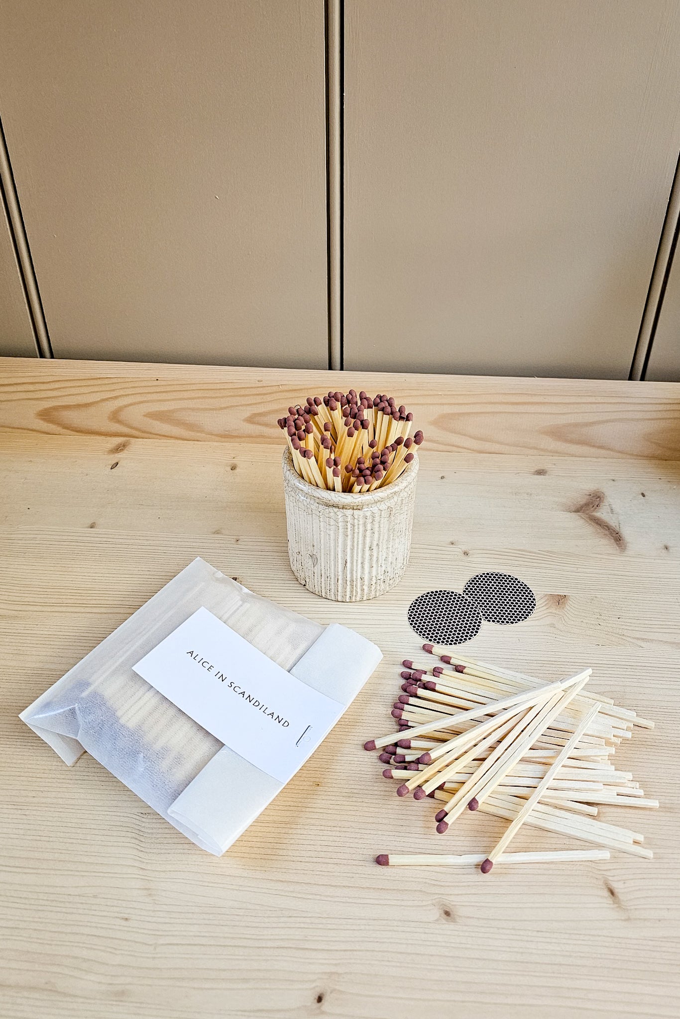 Alice in Scandiland extra long matches refill pack with strike pads, shown alongside a filled ribbed ceramic match pot