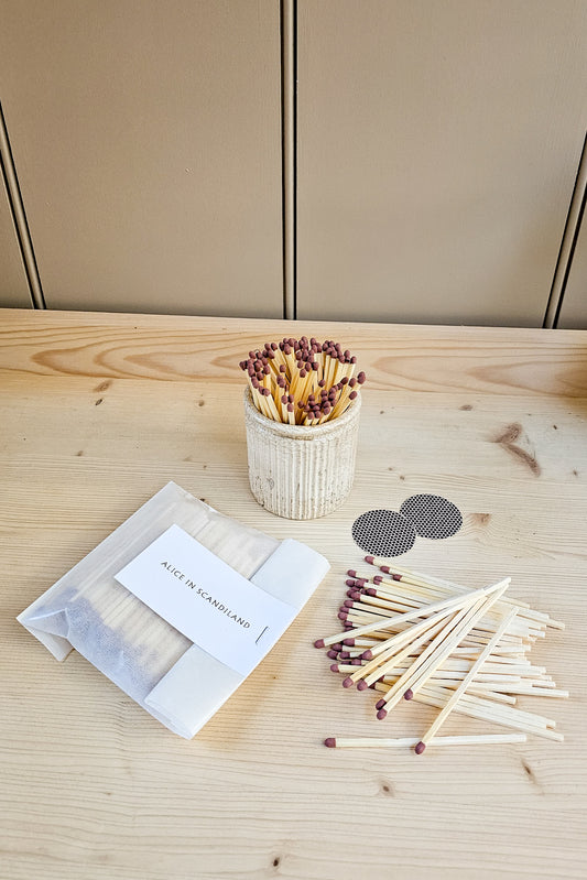 Alice in Scandiland extra long matches refill pack with strike pads, shown alongside a filled ribbed ceramic match pot