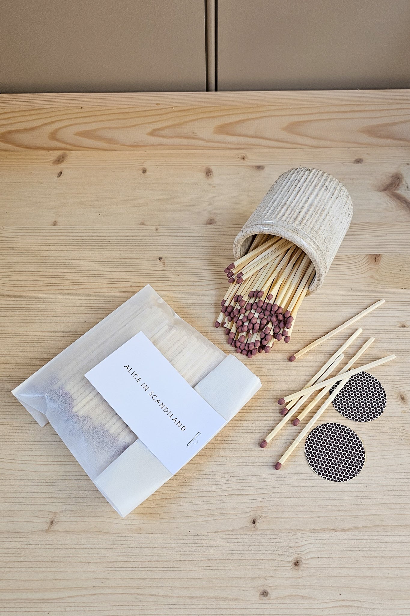 Alice in Scandiland extra long matches refill pack with two circular strike pads, spilling from a ribbed ceramic match pot