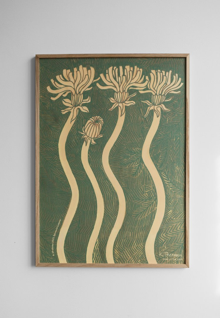 A framed poster featuring abstract floral designs in gold/beige colour on a green background hanging on a white wall.