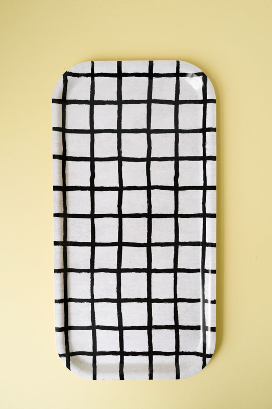 Rectangular tray with black grid pattern on a light yellow background.