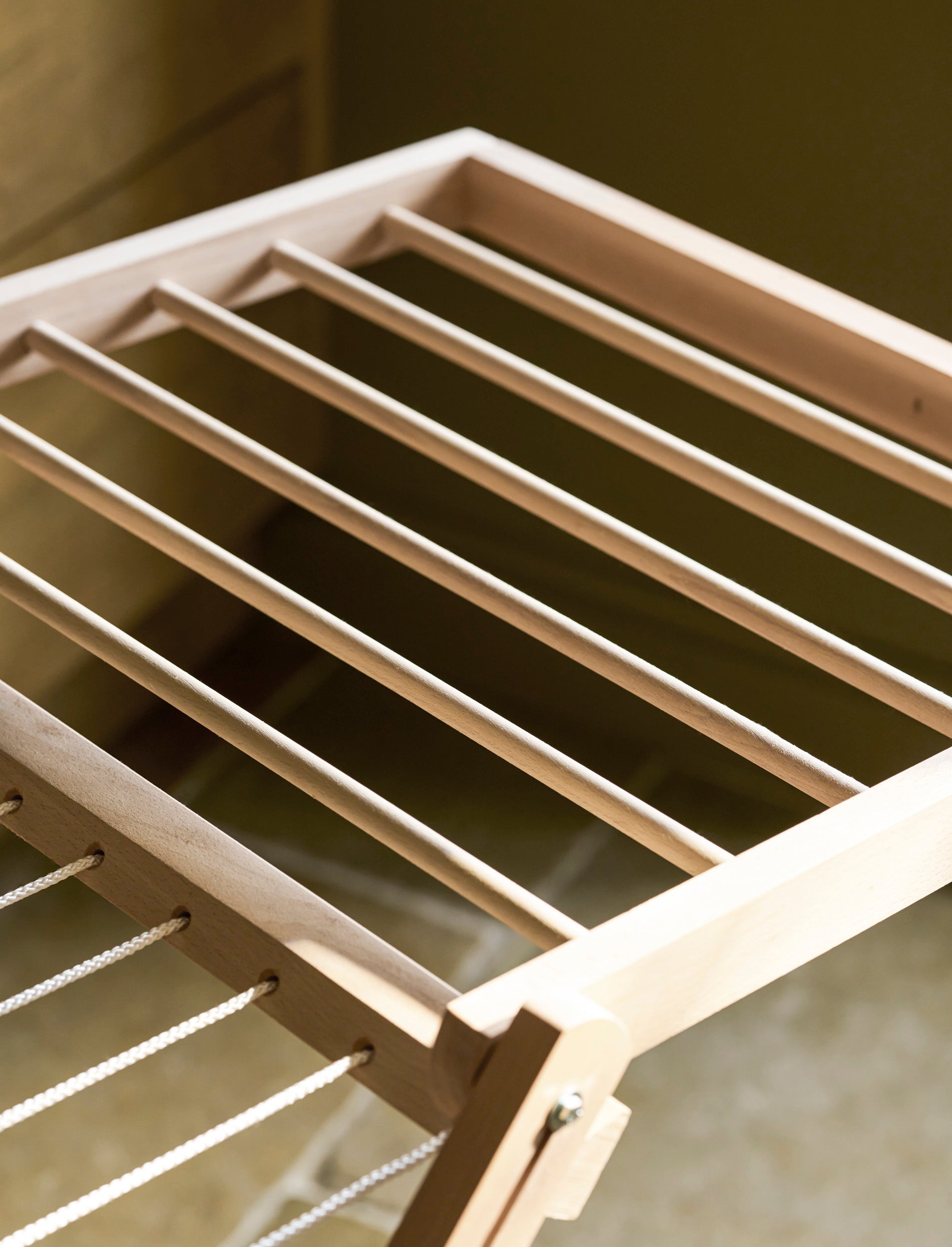 Close up of a Garden Trading Chalford Airer, made from raw Beech wood, displayed folded out in a neutral kitchen setting. 