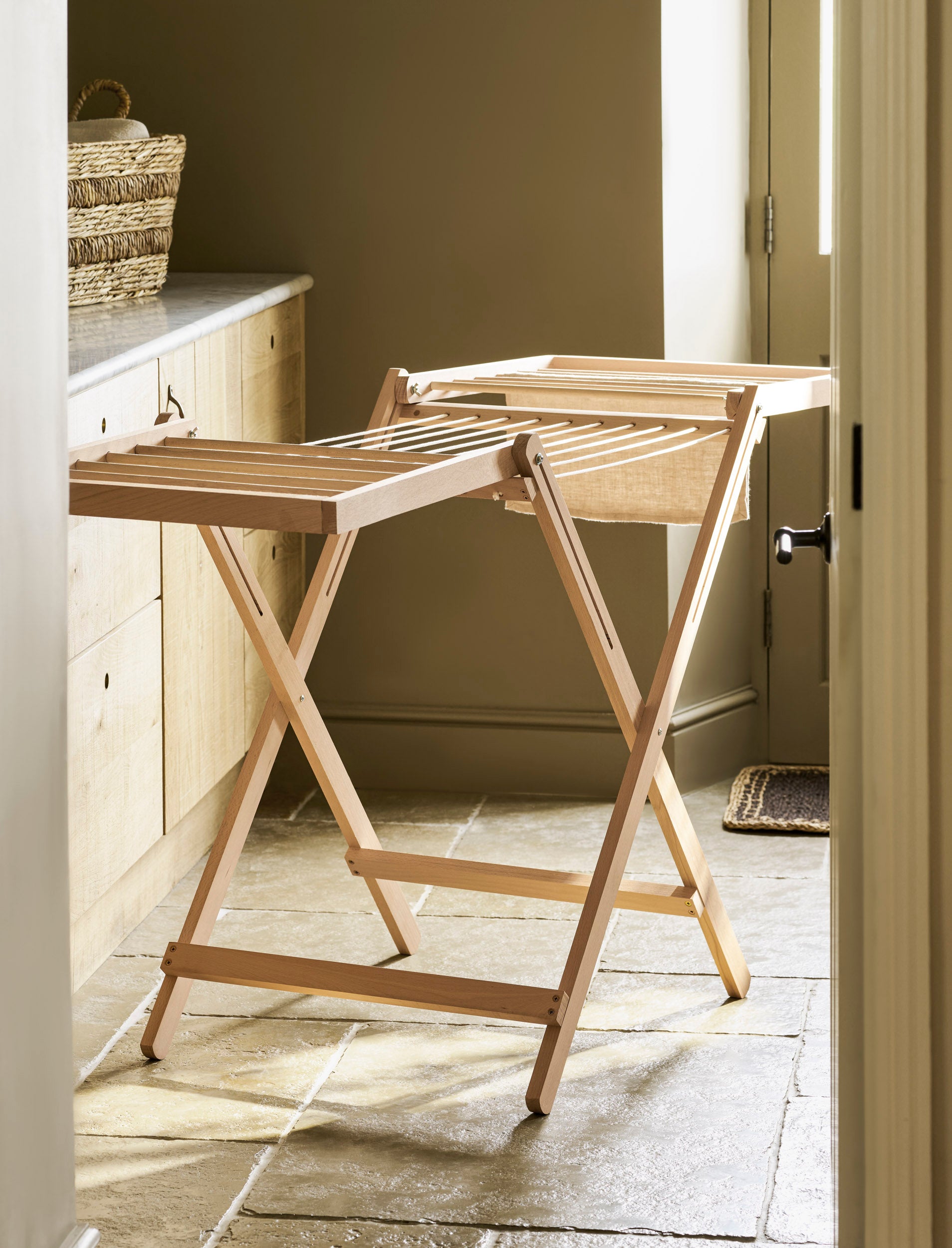 Garden Trading Chalford Airer, made from raw Beech wood, displayed folded out in a neutral kitchen setting. 