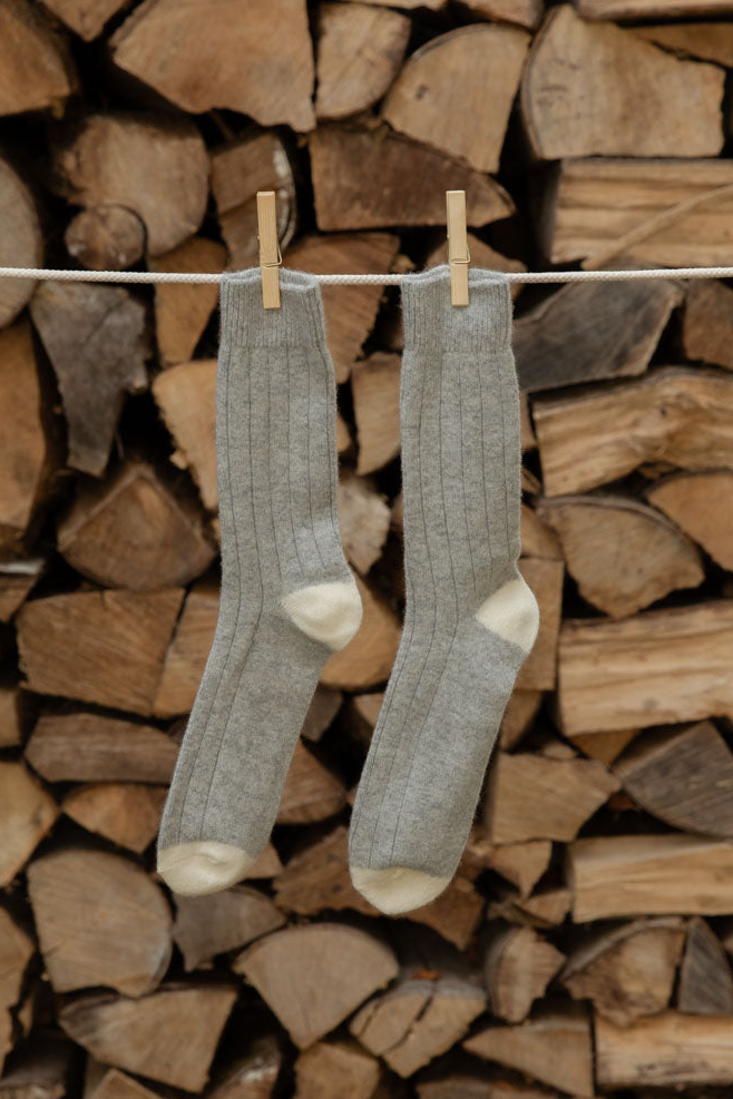 Le Bon Shoppe Classic Cashmere Socks in Grey Melange, ribbed grey with cream heels and toes, pegged against stacked logs