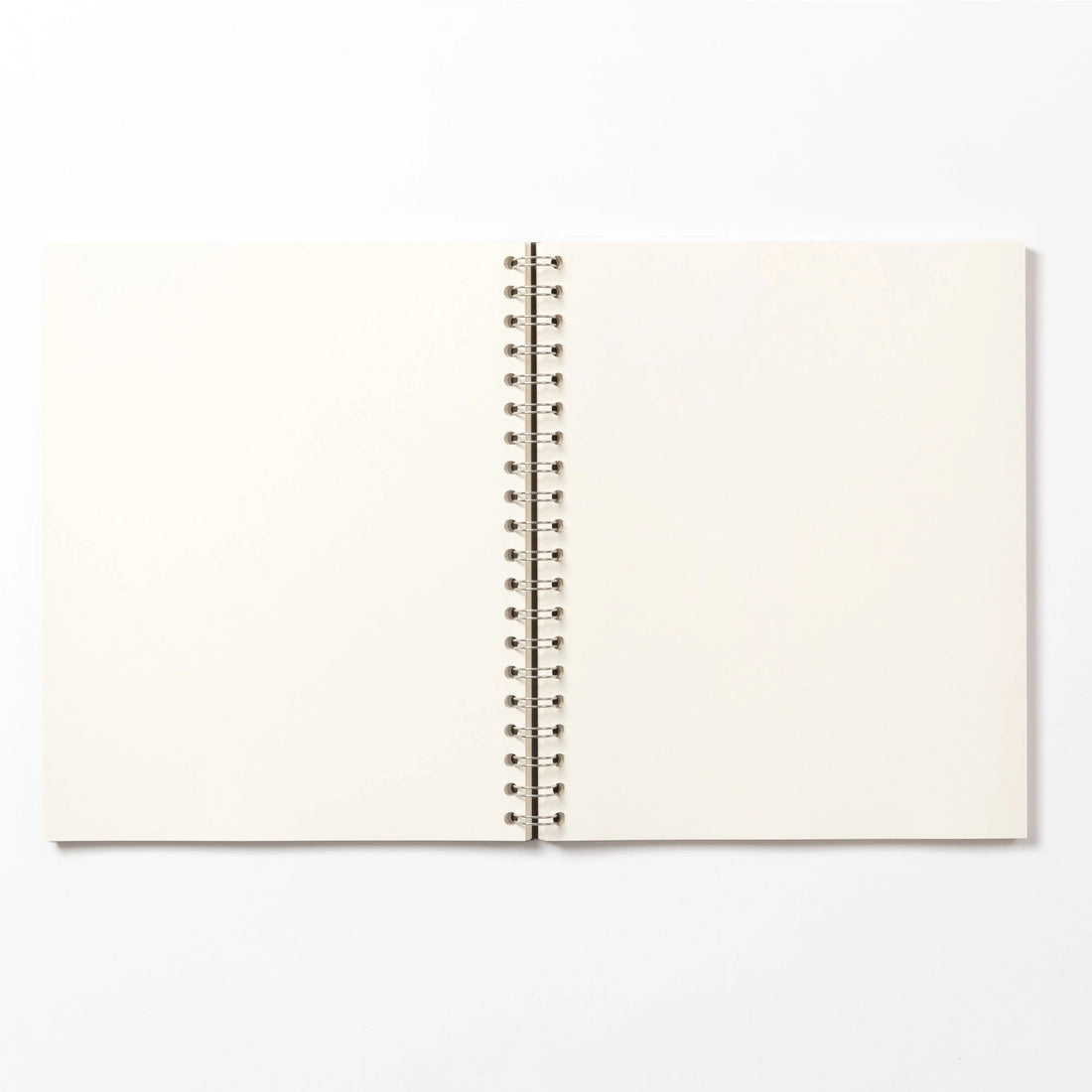 Open notebook with blank pages on a white background