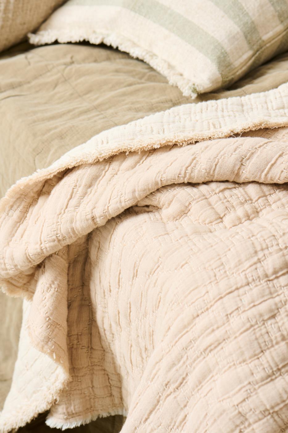 Close-up of textured beige fabric with a soft, plush finish.