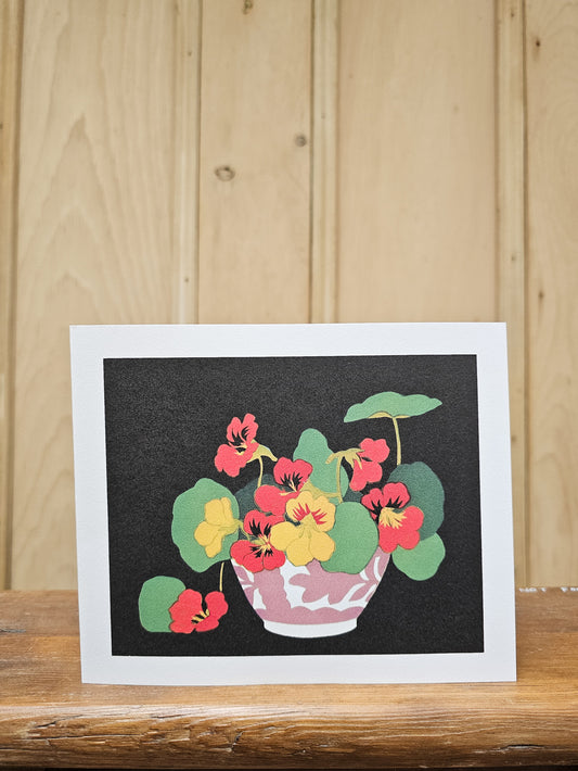 Greeting card reproducing John Hall Thorpe's bold print of nasturtiums, showing red and yellow flowers with round green leaves in a pink bowl against a black background