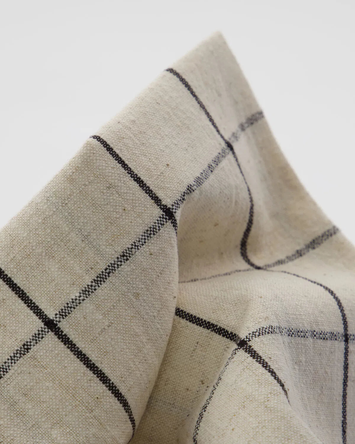 Close up image of the texture and design of a Join Napkin against a white background.