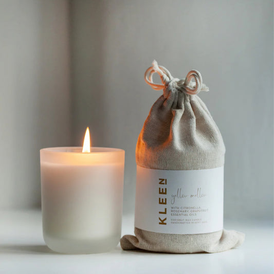 Kleensoaps coconut wax candle in a frosted glass jar, burning with a steady flame
