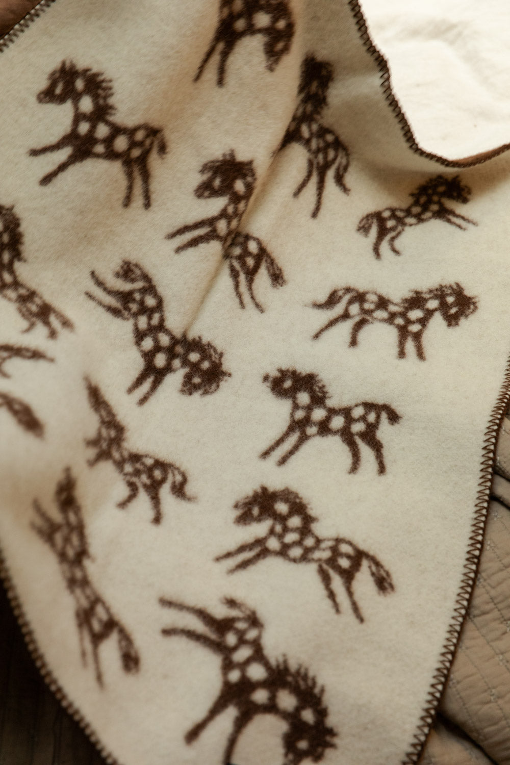 Pattern of horses on a textured fabric surface