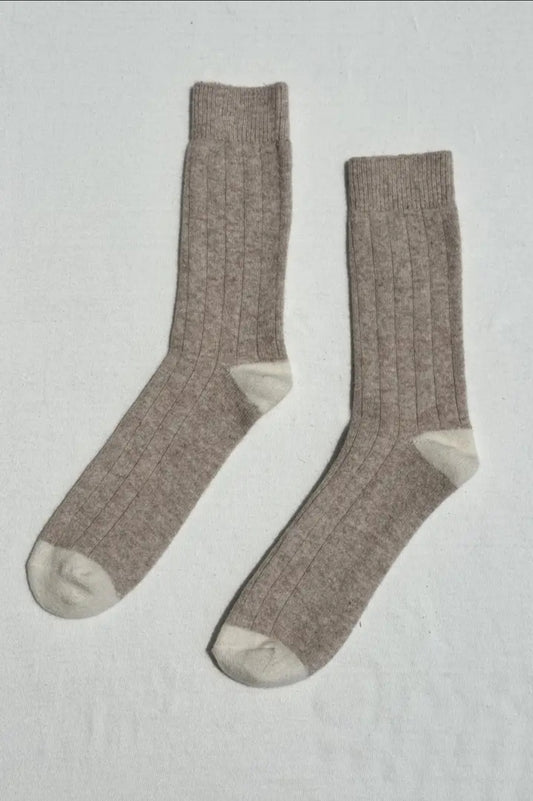Pair of fawn socks on a light grey background.