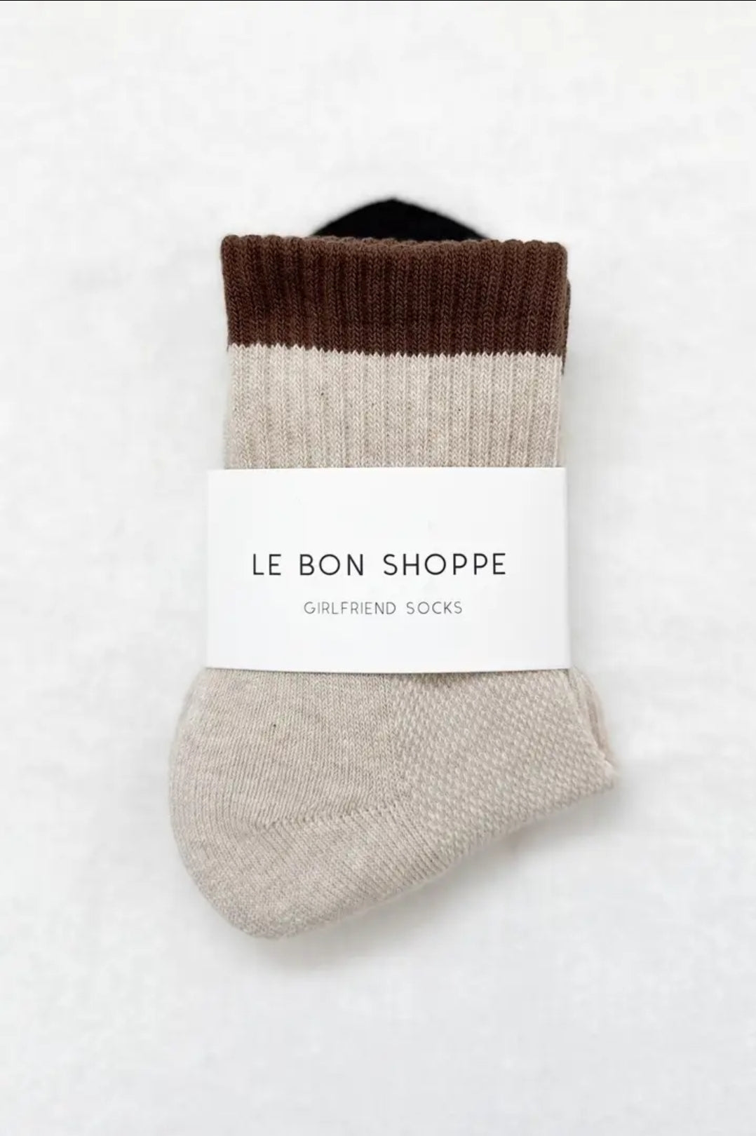 Pair of color-blocked socks with a visible brand label on a white background.