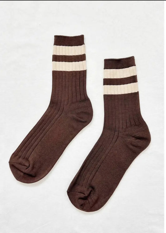 Pair of brown socks with white stripes on a white background.