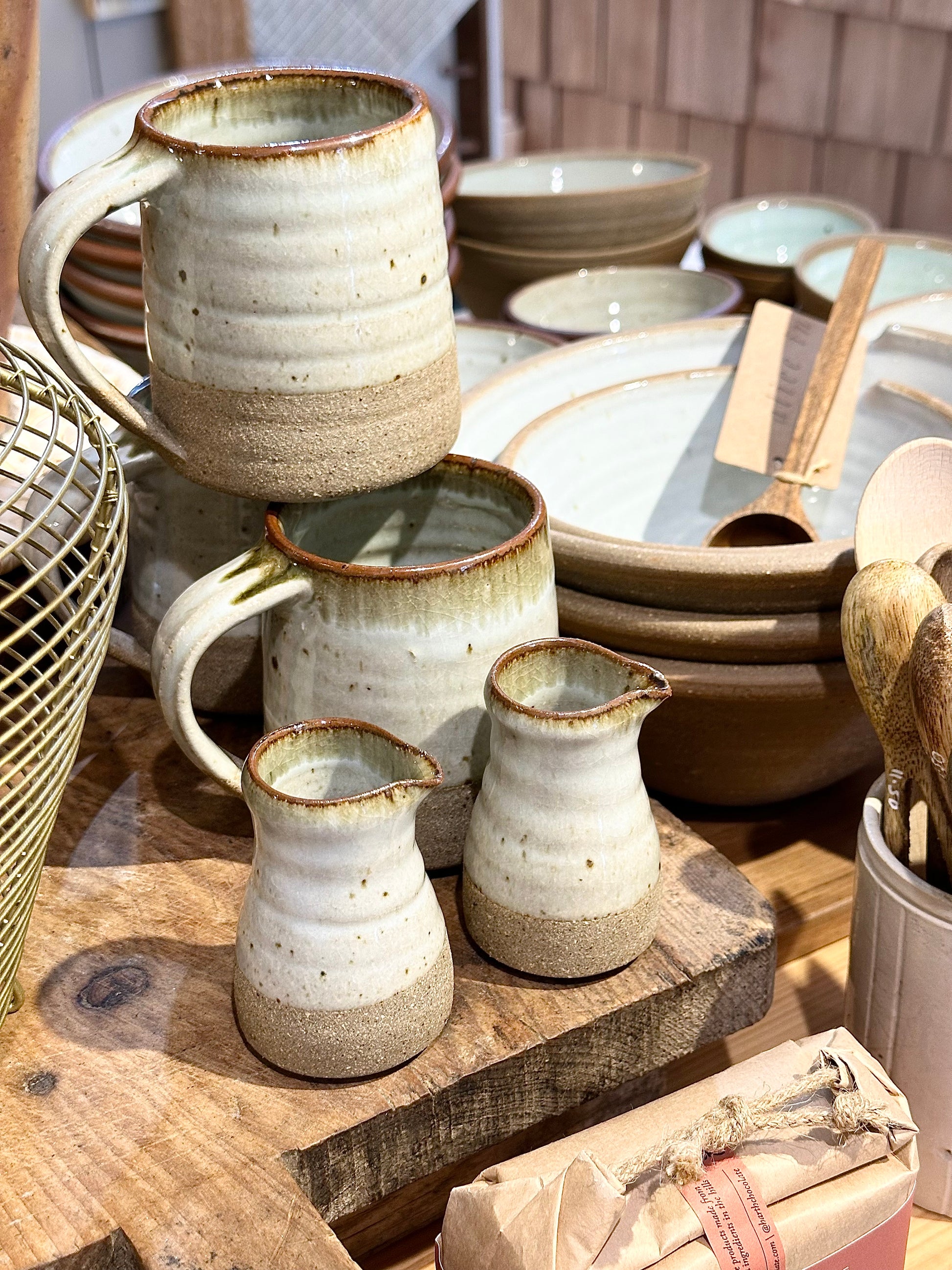 Collection of Leach Pottery, featuring a pourer, mugs and handthrown bowls in the Alice in Scandiland shop.
