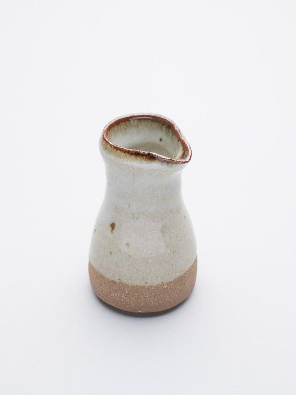 A Leach Pottery stoneware pourer with a 100ml capacity against a white background.