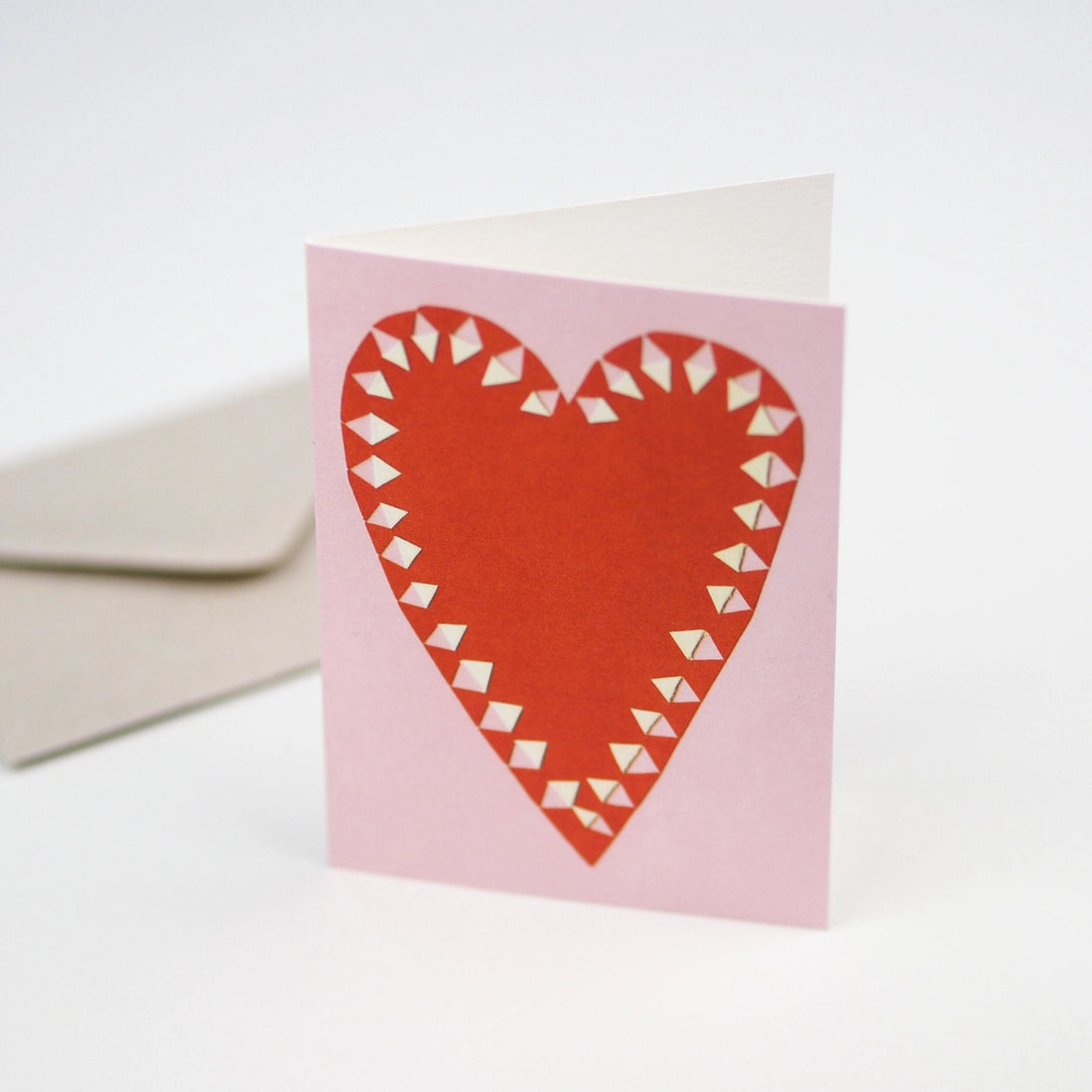 Card with red heart design on pink background