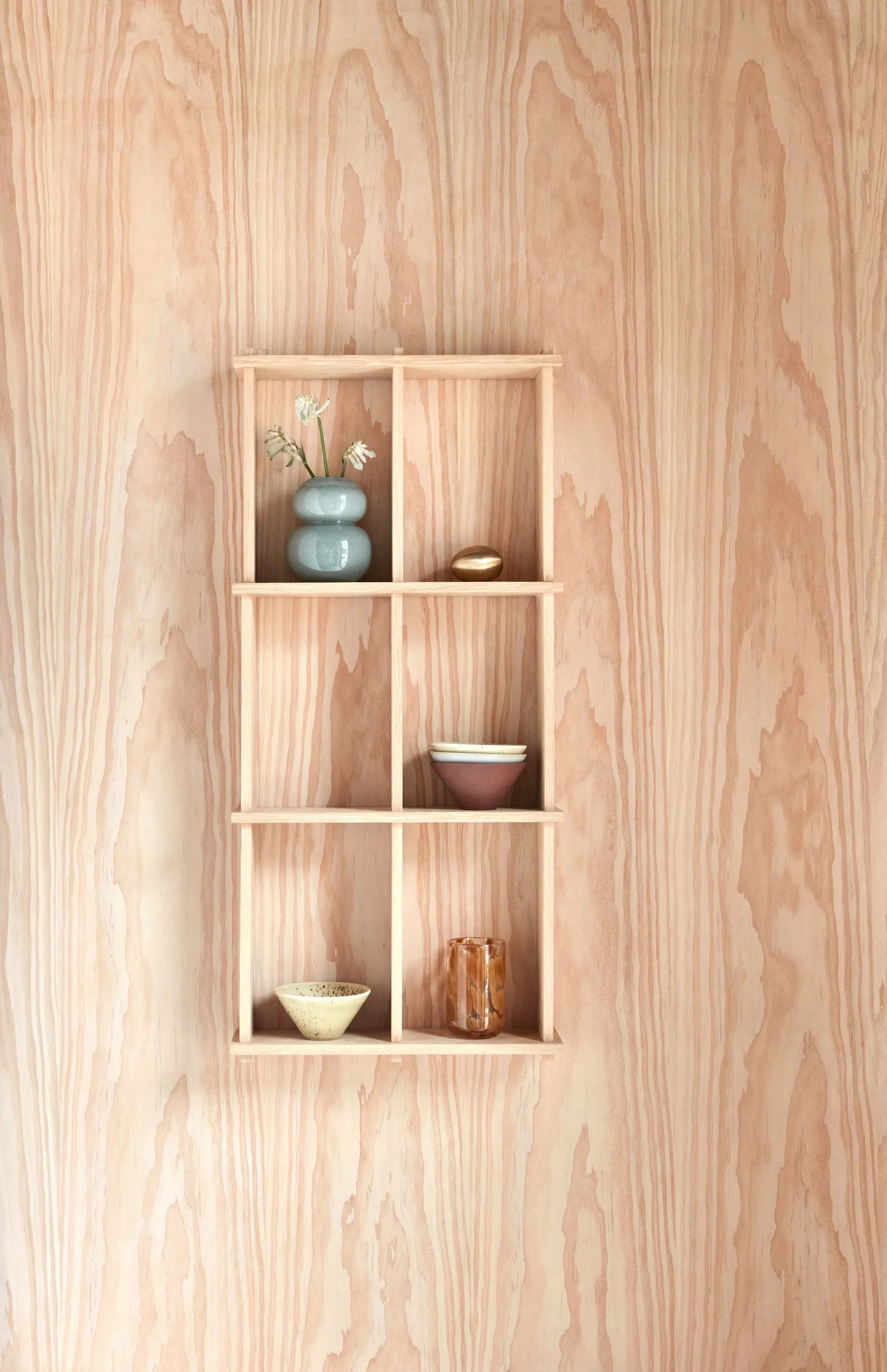 OYOY Grid Shelf small in solid oak mounted on plywood wall, styled with ceramic vase, bowls and glassware