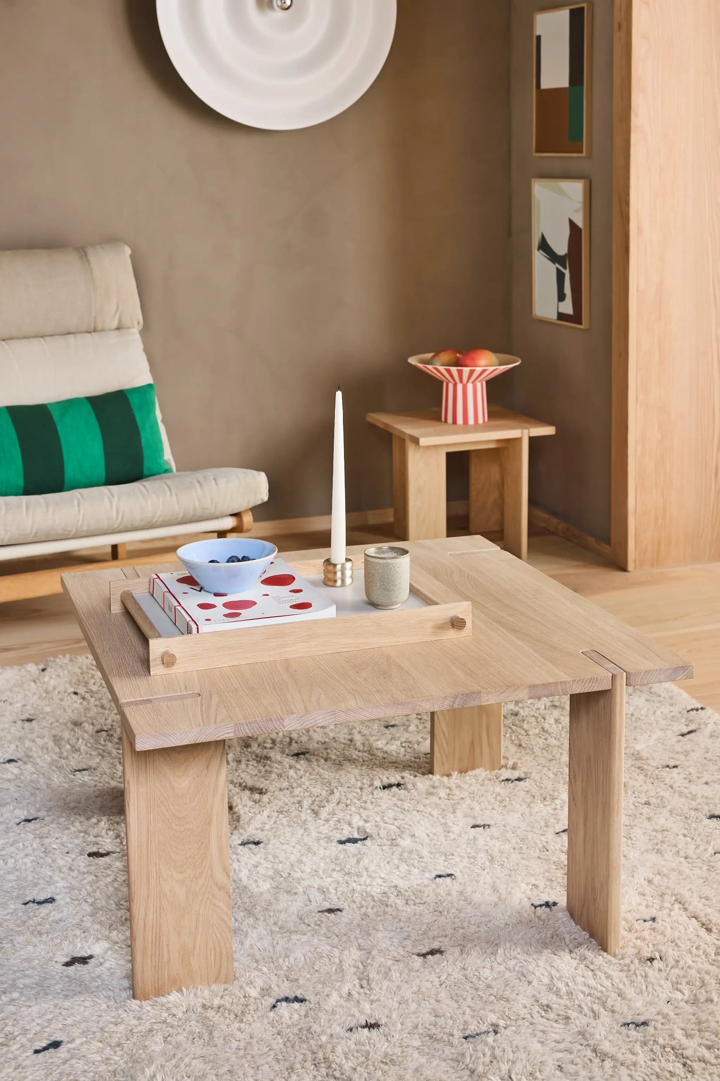 OYOY Square Coffee Table in solid oak styled with books, candle and ceramic bowl on shaggy rug