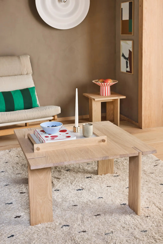 OYOY Square Coffee Table in solid oak styled with books, candle and ceramic bowl on shaggy rug