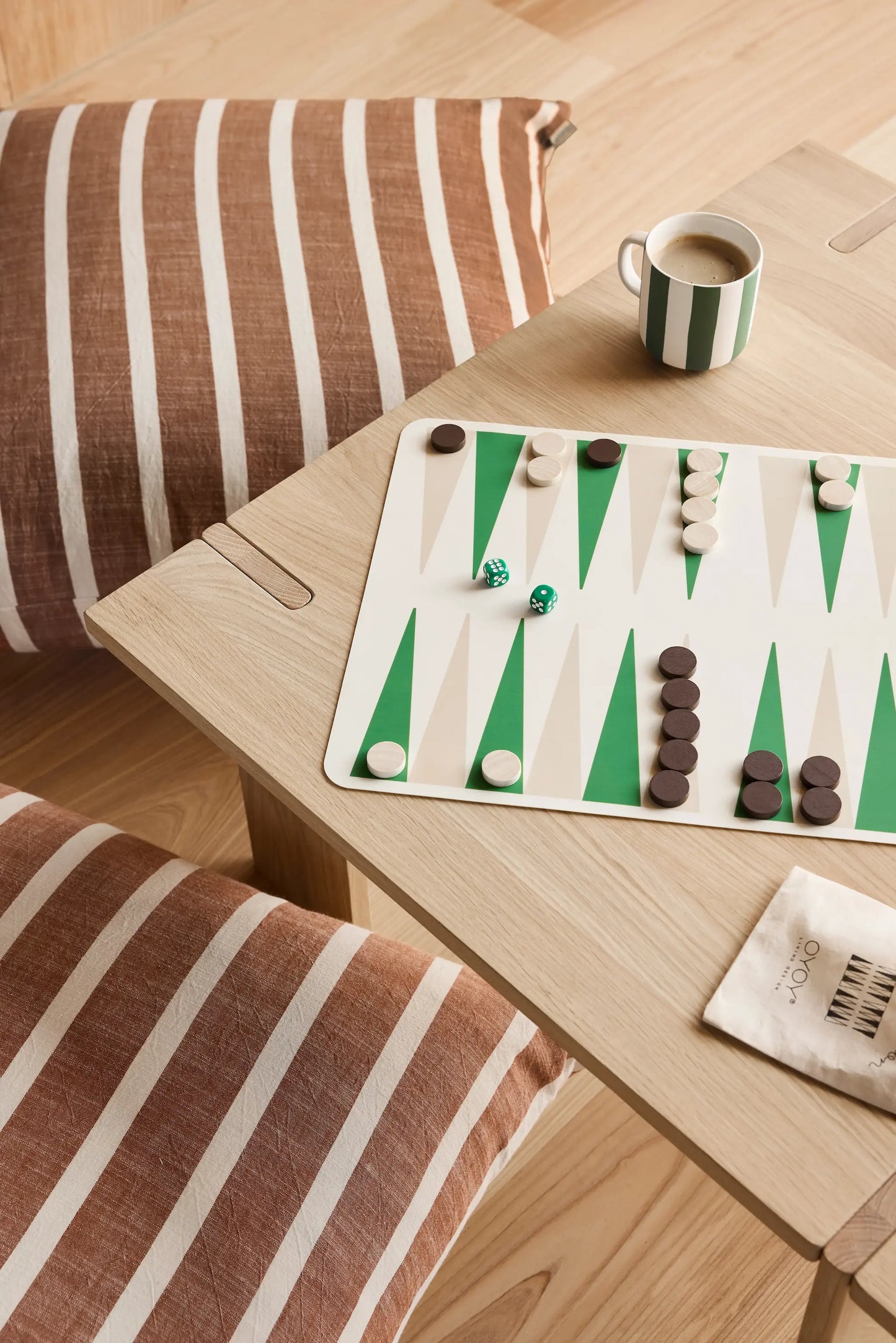 OYOY Square Coffee Table in solid oak from above with backgammon board, striped mug and floor cushions