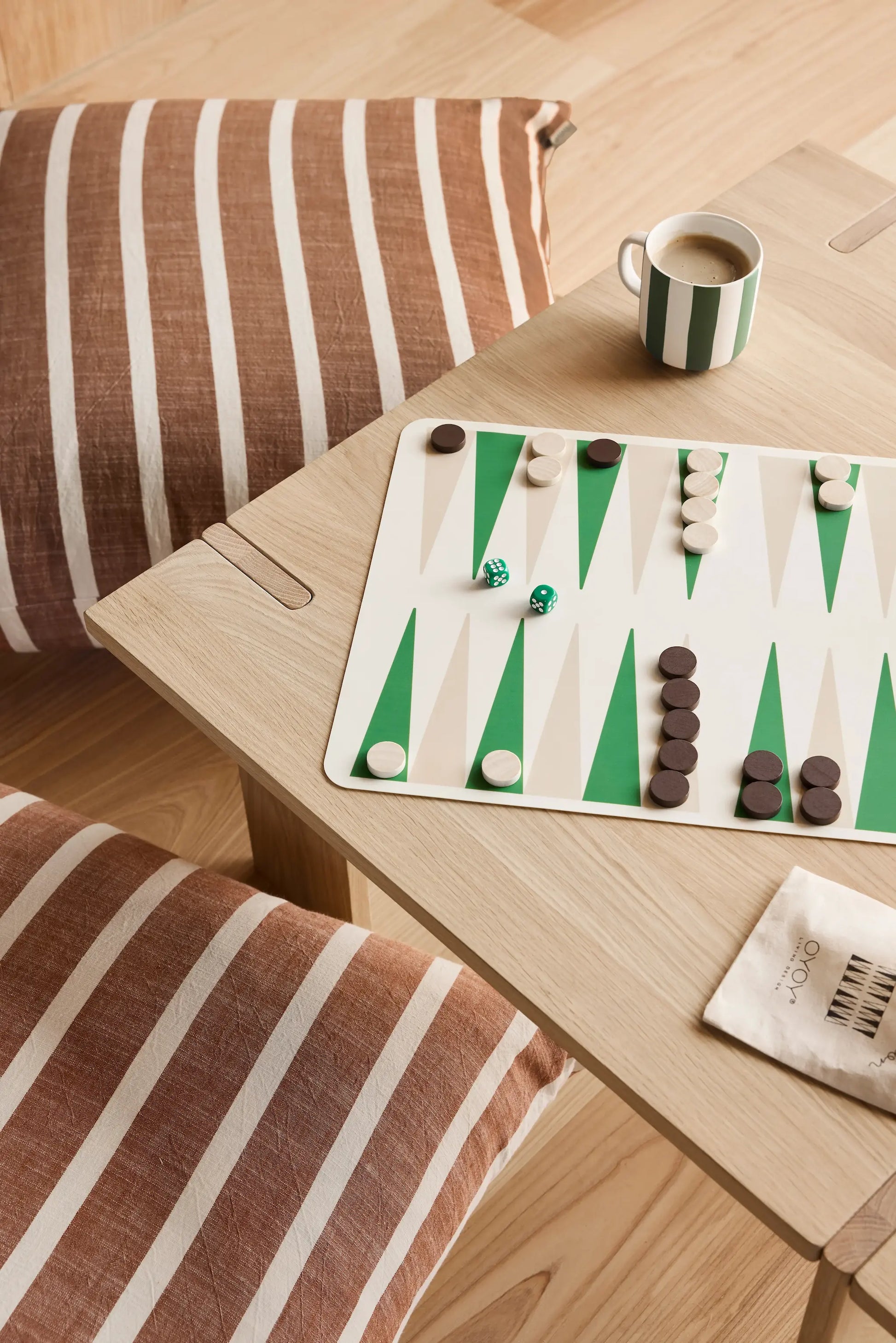 OYOY Square Coffee Table in solid oak from above with backgammon board, striped mug and floor cushions