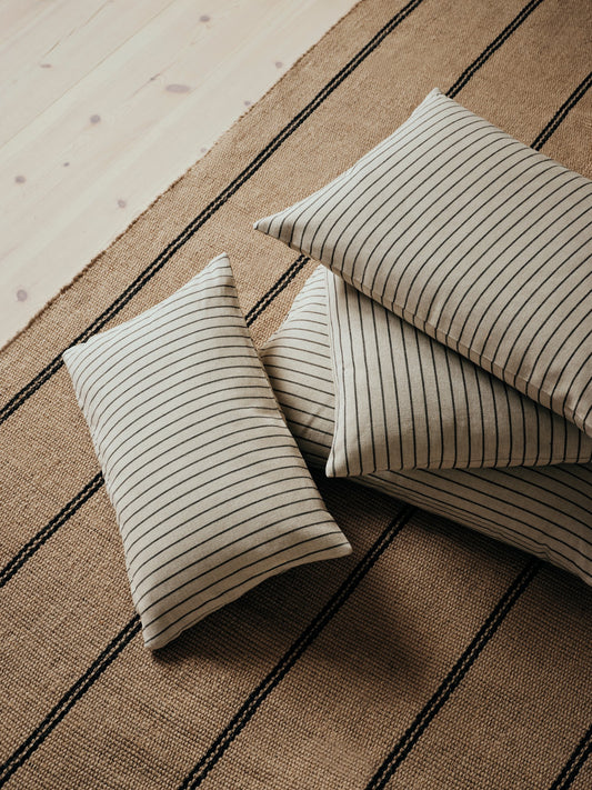 Striped pillows on a textured surface.