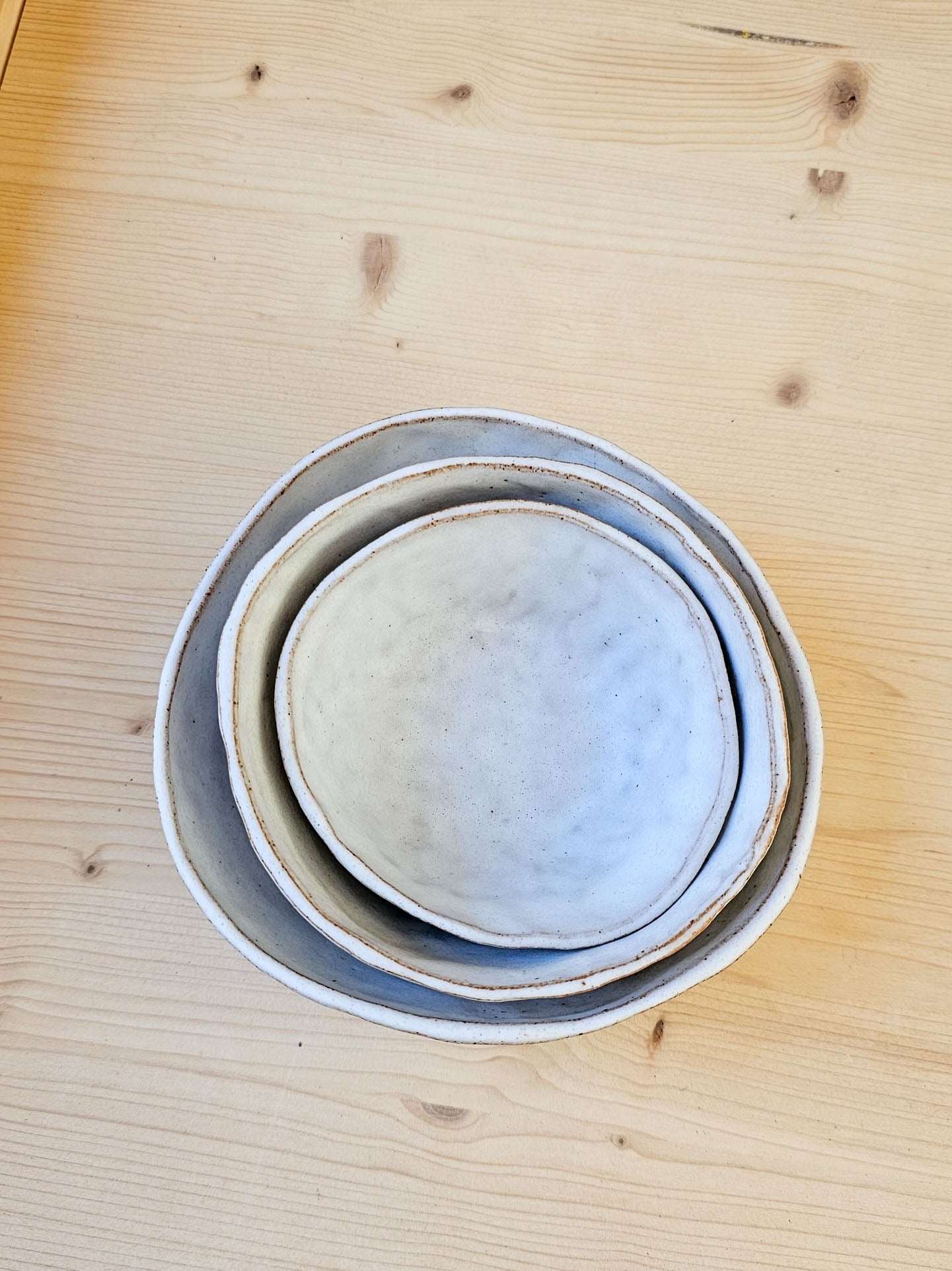 Stack of ceramic bowls on a wooden surface