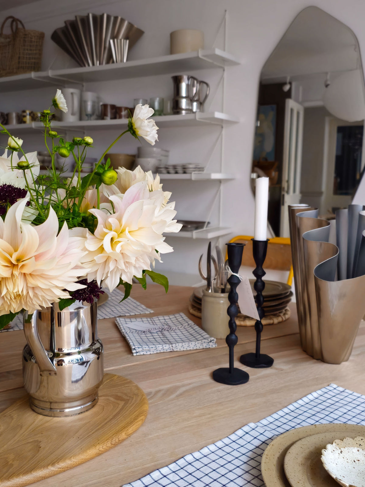 Scandinavian homeware shop interior at Alice in Scandiland, Lostwithiel, with café au lait dahlias in a chrome jug on an oak table