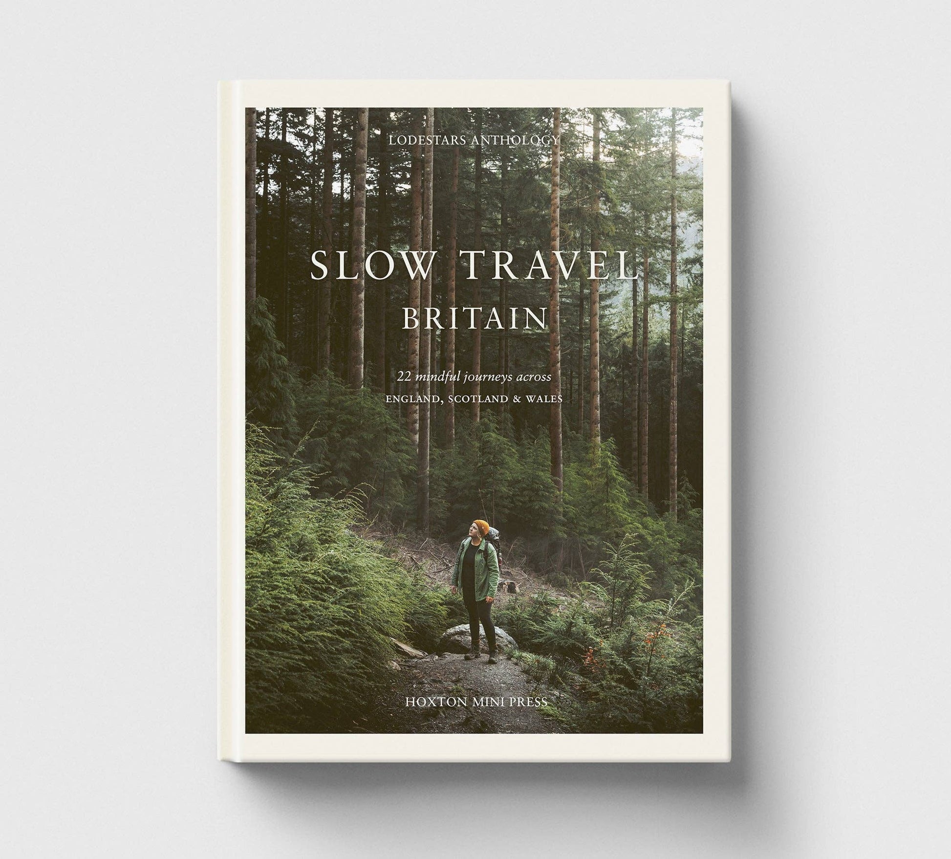 Book cover of 'Slow Travel Britain' with a person walking through a forest.