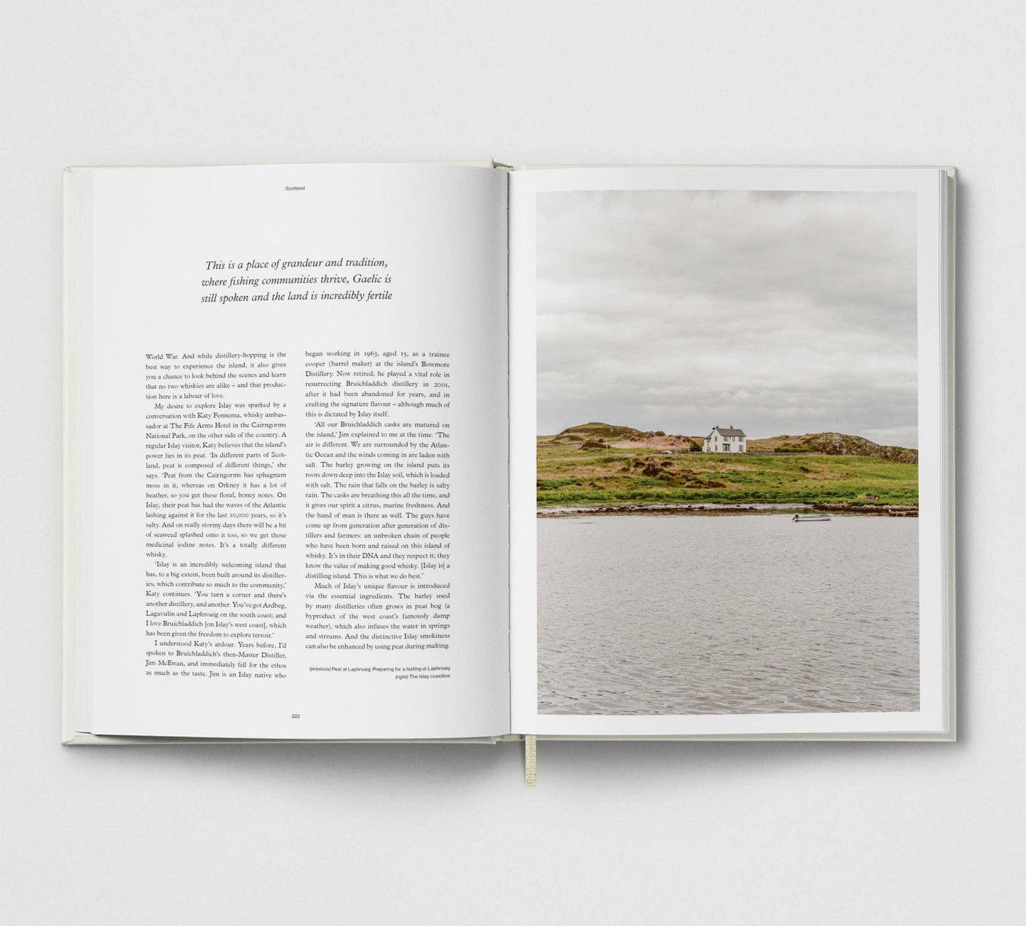Open book with text on one page and a scenic photograph of a house on an island on the other.