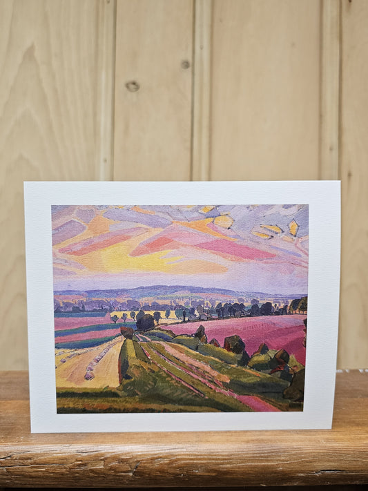 Greeting card reproducing Spencer Gore's painting of the Icknield Way, showing vivid pink and purple fields beneath a dramatic sunset sky of orange and yellow