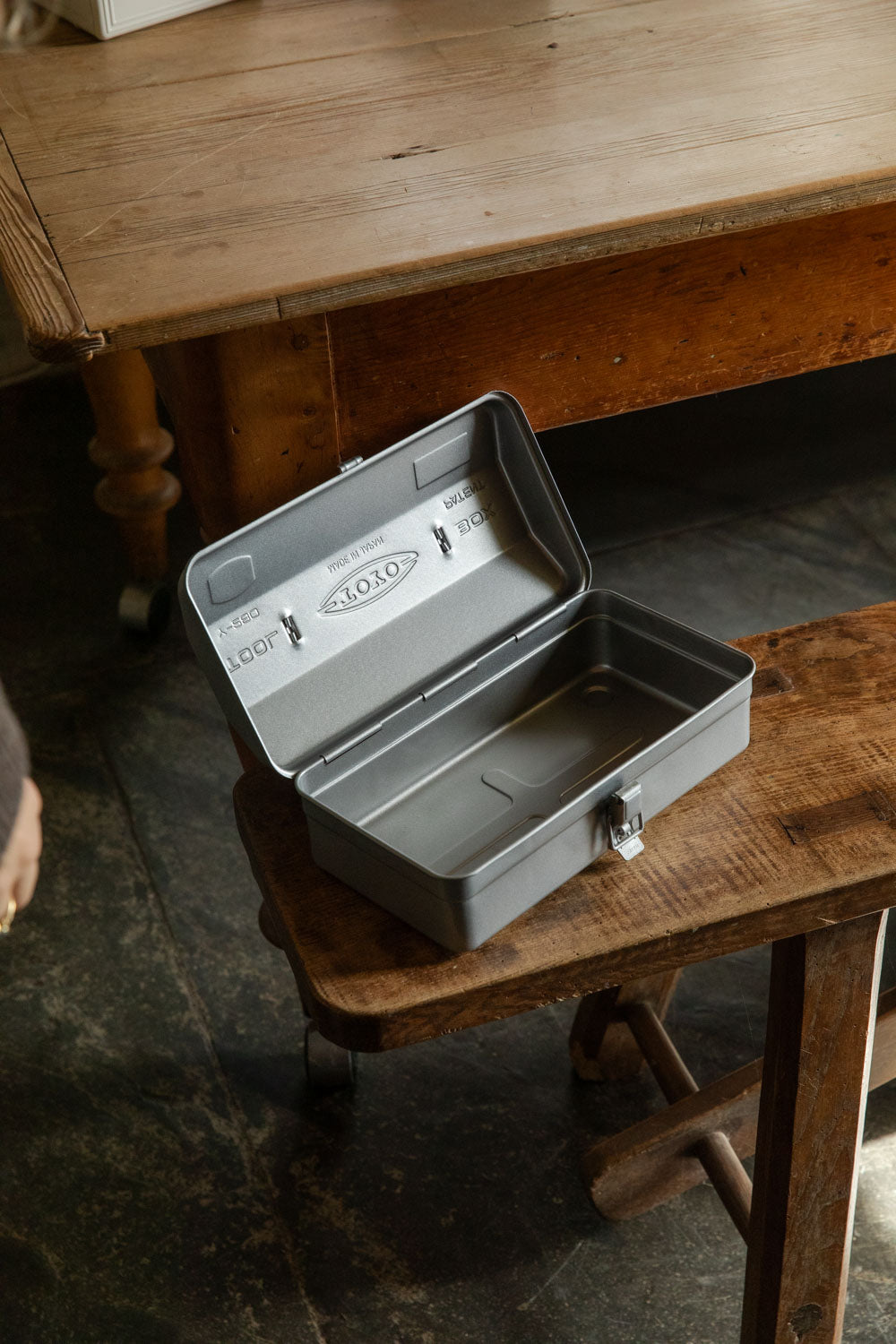 Silver Toyo Y-280 toolbox open on a wooden bench