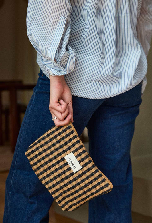 Person holding a Vichy Cafe cotton pouch.