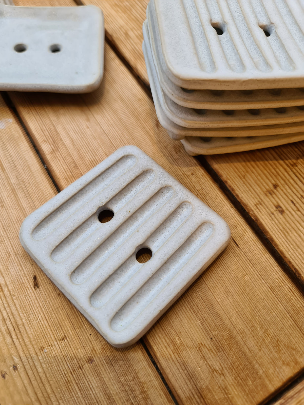 Small square white ceramic soap dish with drainage holes