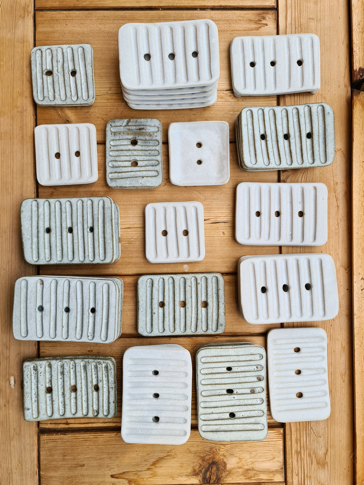 Small square and large rectangular ceramic soap dishes in white and rustic glazes from above