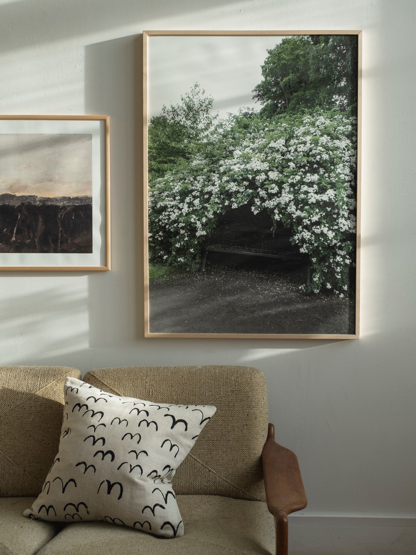 Framed poster of a photograph taken at the Botanical Gardens, Gothenburg, of a bench shrouded in flowers. 