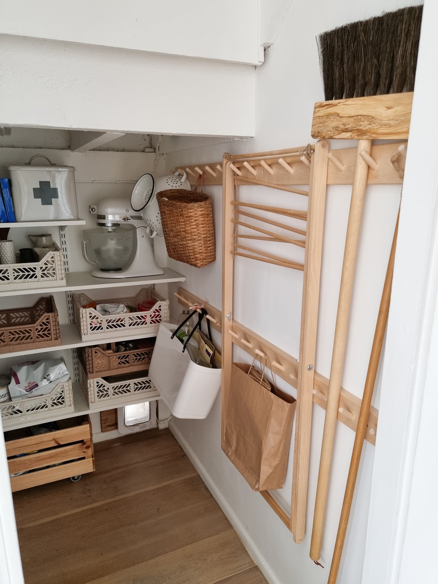 Foldable wooden wash drier airer shown stored in a cupboard when not in use.