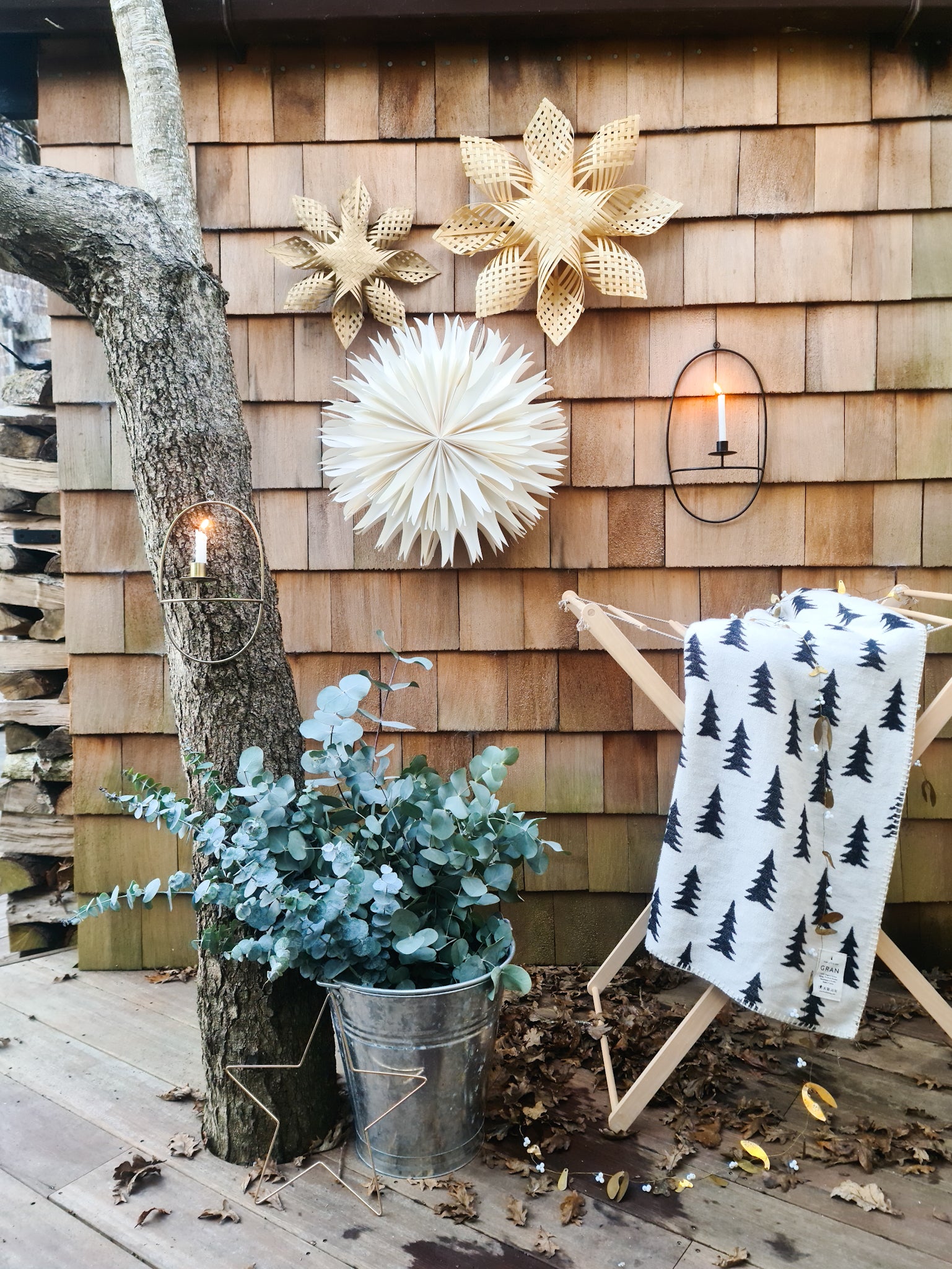 Foldable wooden wash drier airer with a muslin towel on it, placed in a garden.