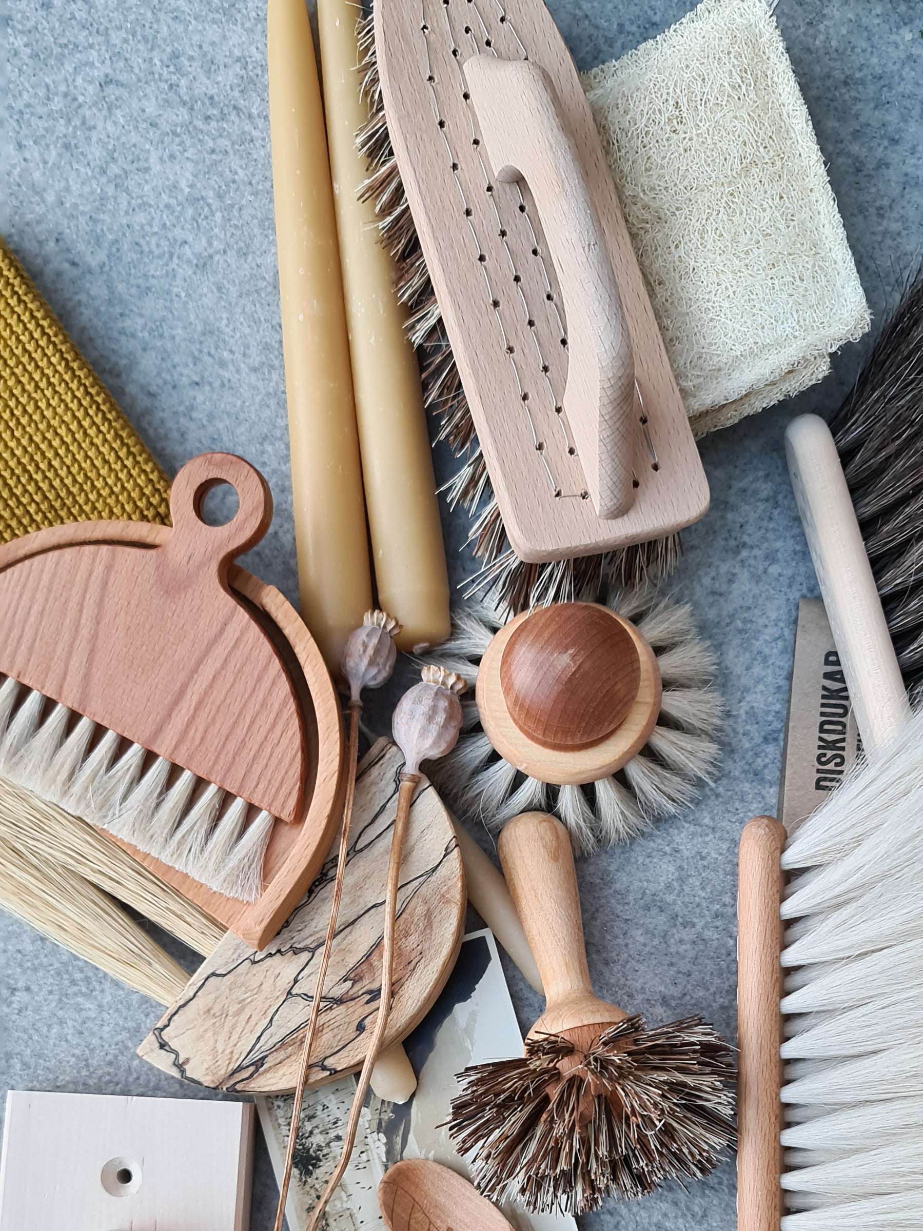 A wooden table brush with a matching dustpan, scattered amongst other wooden items.