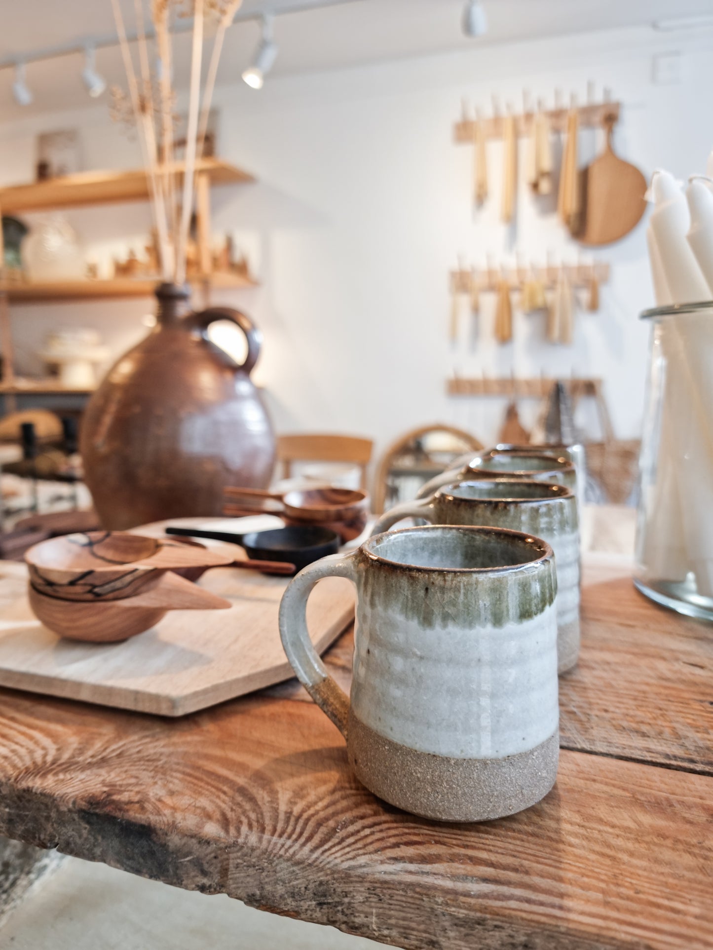 A Leach Pottery dolomite espresso mug displayed within the Alice in Scandiland shop, with various other items in the background.