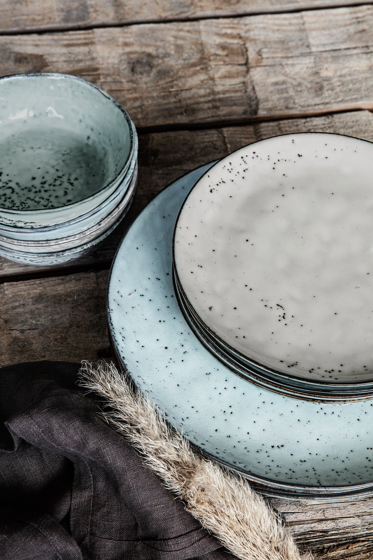 Set of rustic dinnerware on a wooden table.